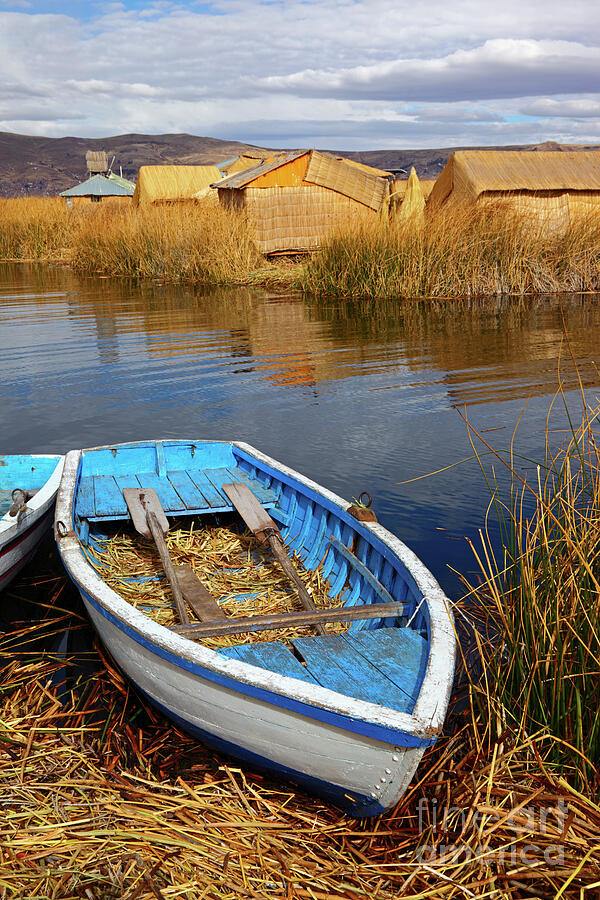 Wooden rowing boat on the Uros Islands Lake Titicaca Peru Photograph by James Brunker