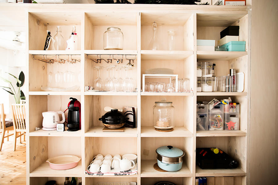 Wooden shelves with dishes arranged Photograph by Taiyou Nomachi