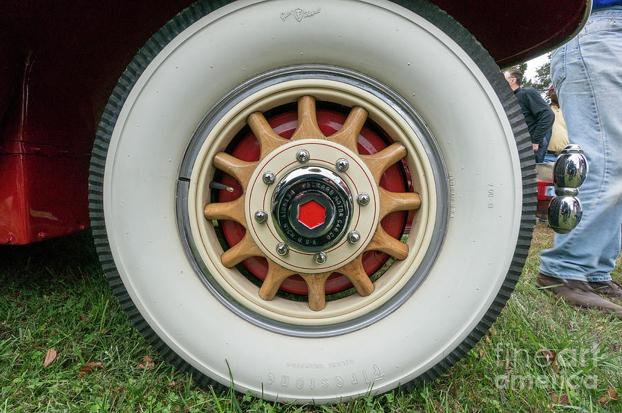 Wooden-spoked wheel of a vintage Packard at an antique car show Photograph by William Kuta