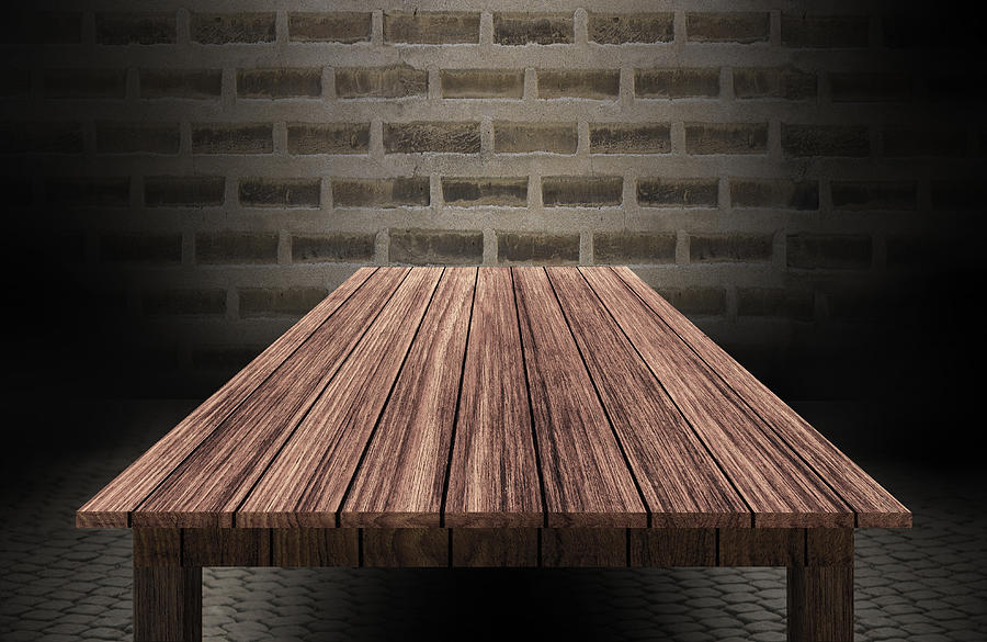 Wooden Table In Front Of Brick Wall Photograph by Thanavat