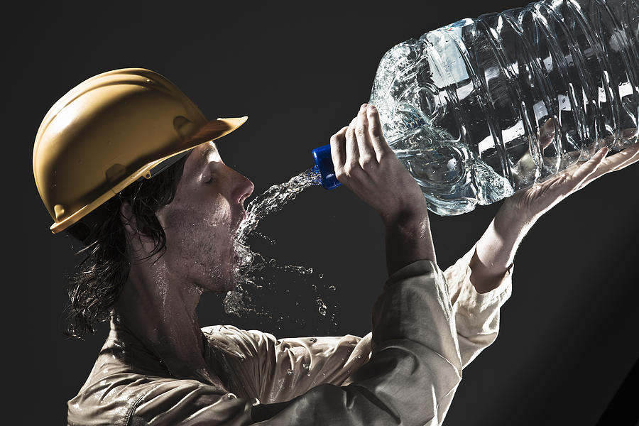 Worker drinking water Photograph by Buena Vista Images