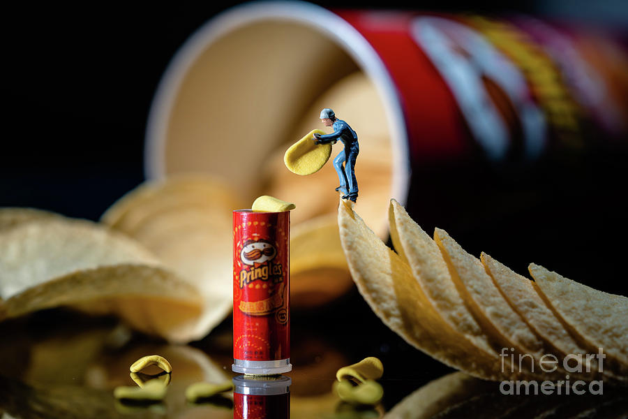 worker is packing a tiny packet of Pringles t5 Photograph by Historic ...