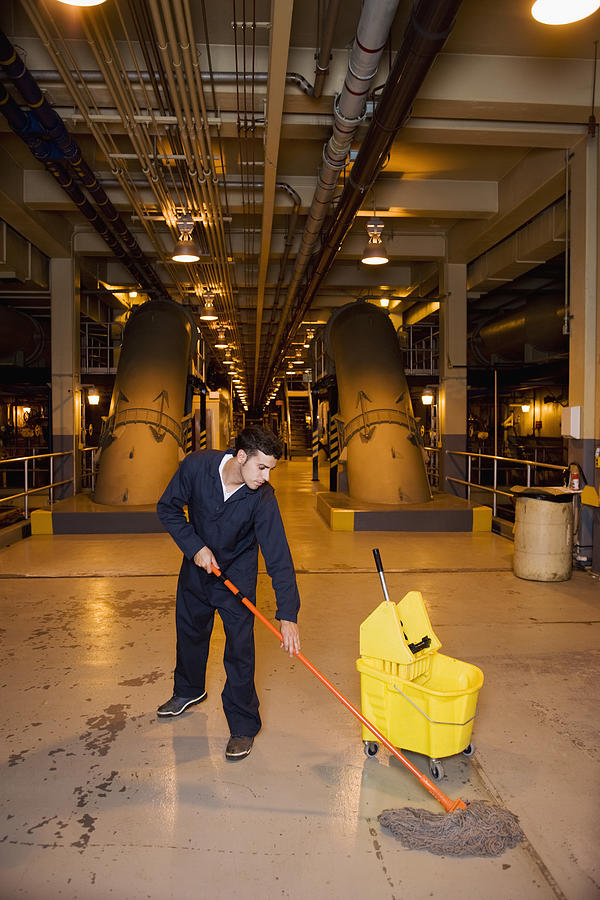 Worker mopping floor Photograph by Thinkstock Images
