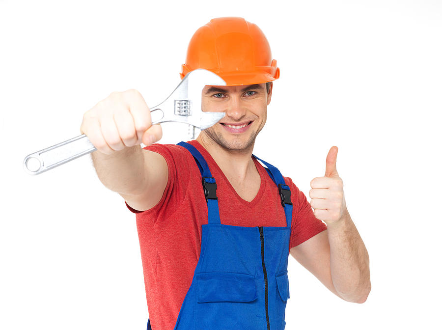 Worker with spanner showing thumbs up sign Photograph by ValuaVitaly