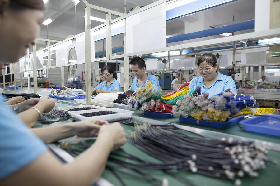 Workers at an electronics factory in Dongguan, China Photograph by FangXiaNuo