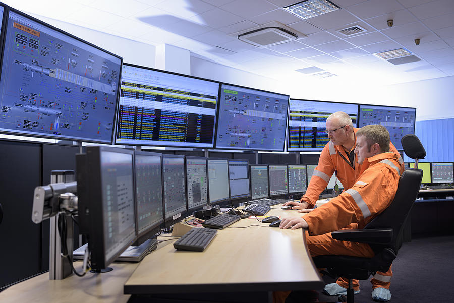 Workers in control room of gas-fired power station Photograph by Monty Rakusen