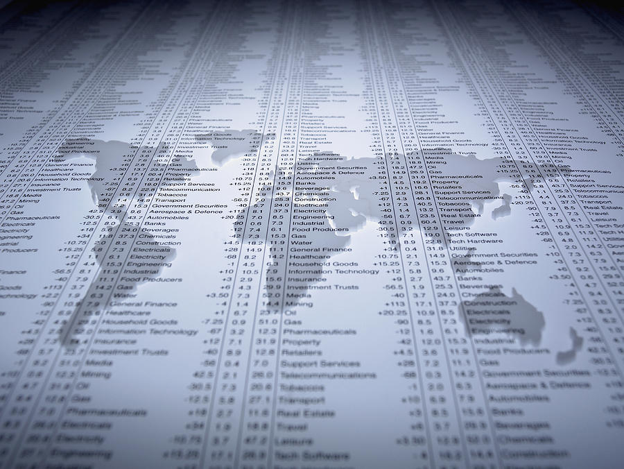 World map outline on list of share prices Photograph by Adam Gault