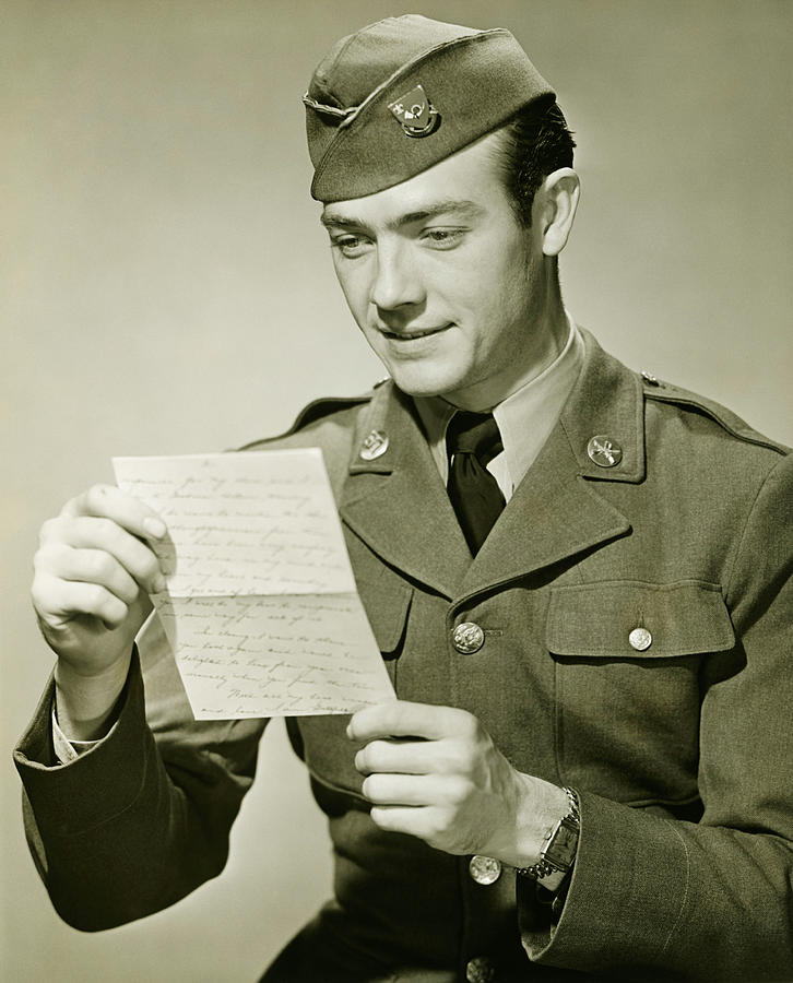 World War II Army solider reading letter in studio, (B&W), portrait Photograph by George Marks