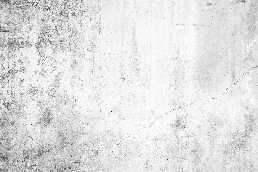 Worn concrete wall texture background with paint partly faded, in black&white. Photograph by Tuomas Lehtinen