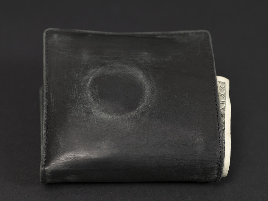 Worn wallet containing banknotes, showing evident condom mark Photograph by Henry Horenstein