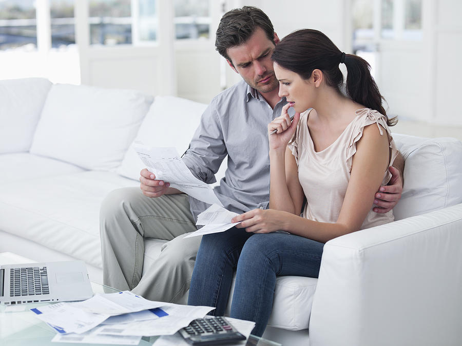 Worried mid adult couple planning home finance Photograph by OJO Images