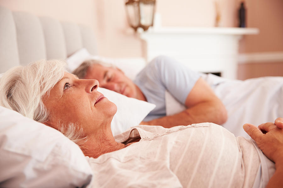 Worried Senior Woman Lying Awake In Bed Photograph by Monkeybusinessimages