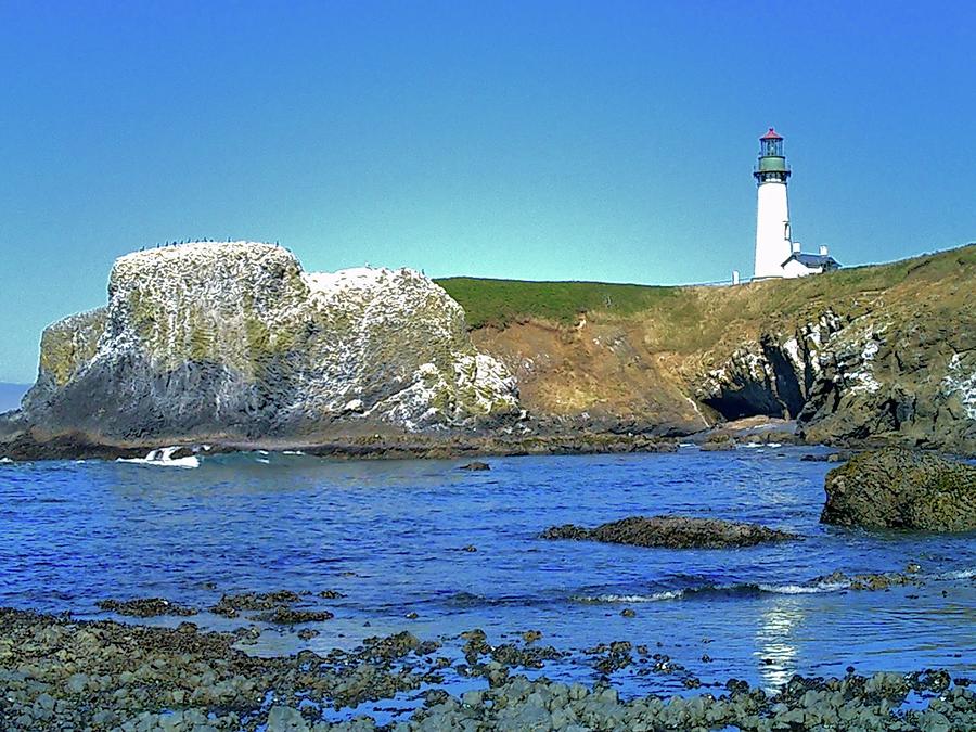 Yaquina Head Lighthouse from the beach Photograph by Scott Carda