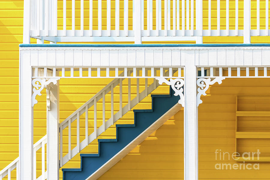 Architecture Photograph - Yellow and blue wooden house in the Magdalen Islands, Canada. These traditional houses are painted in bright tones with decorate carved wood details. Abstract closeup. by Jane Rix