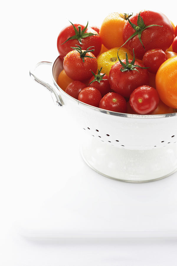 Yellow and red tomatoes in metal strainer Photograph by Martin Poole