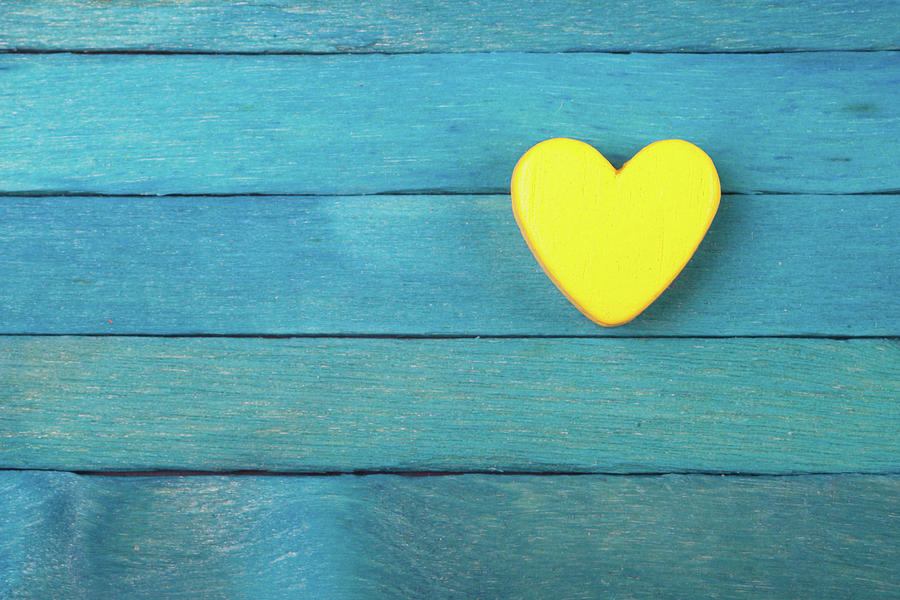 Yellow Heart On Blue Wooden Background Photograph