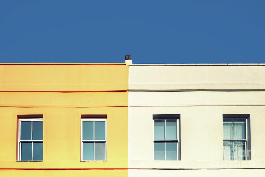 Yellow house, white house and blue sky.  Photograph by Jane Rix