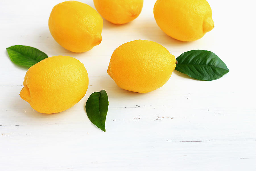 Yellow Lemons On White Wooden Background Photograph by Yulia Naumenko