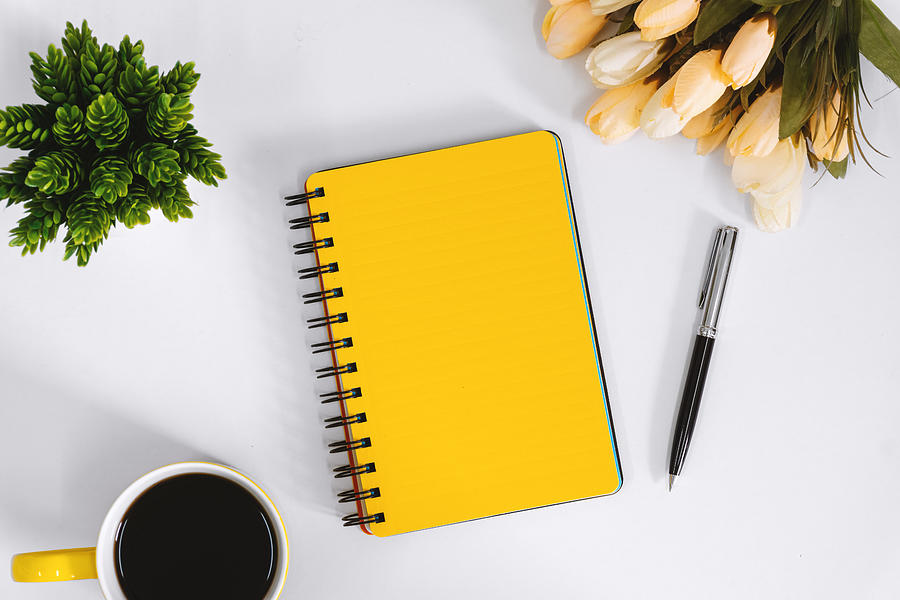 Yellow Notebook and Coffee Mug on Work Desk Photograph by Constantine Johnny