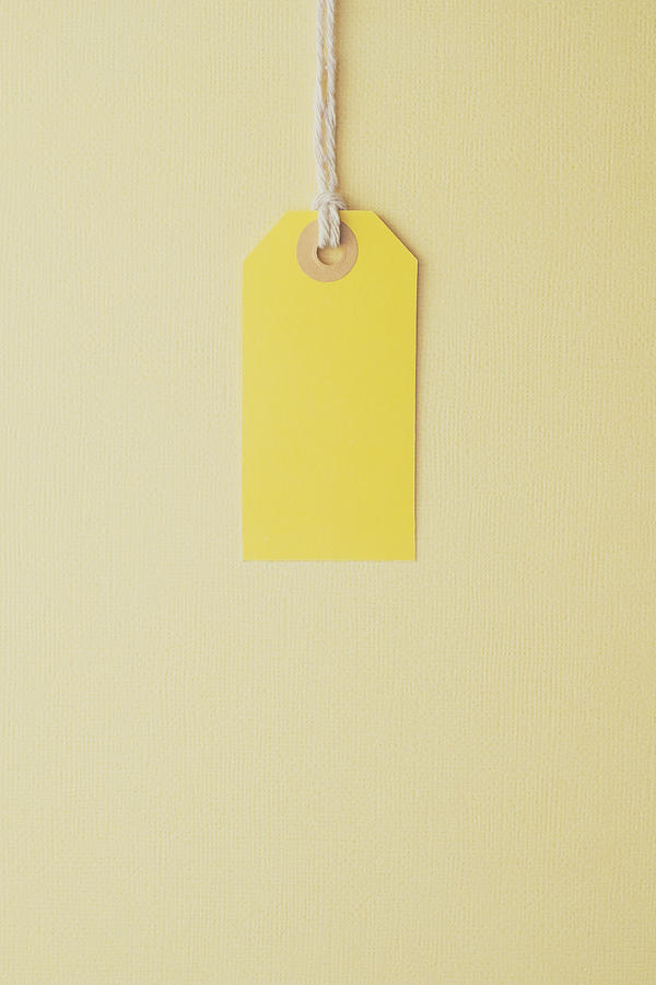 Yellow Paper Label on a Yellow Background Photograph by Catherine MacBride
