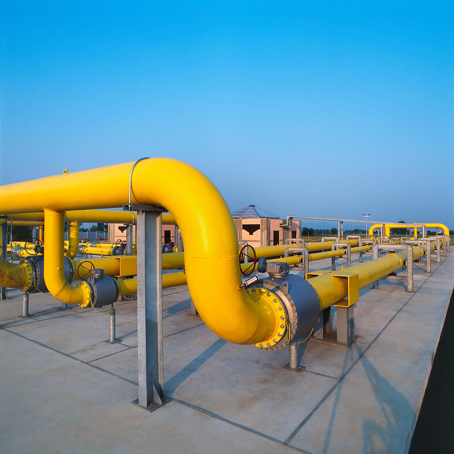 Yellow pipes in a gas distribution station, blue sky background Photograph by DarioEgidi