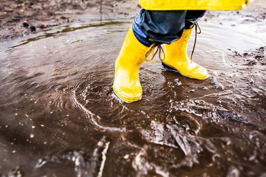 Yellow Rainboots In Puddle Photograph by Wundervisuals