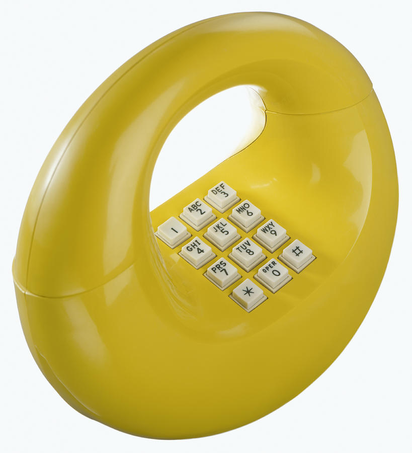 Yellow retro 1970s hoop donut or loop telephone Photograph by Steve Wisbauer