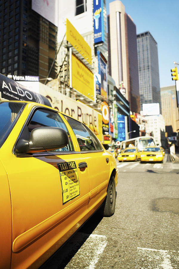 Yellow taxi on a road, Times Square, Manhattan, New York City, New York State, USA Photograph by Glowimages