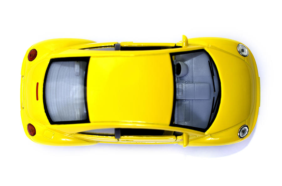 Yellow toy car from above Photograph by Golibo
