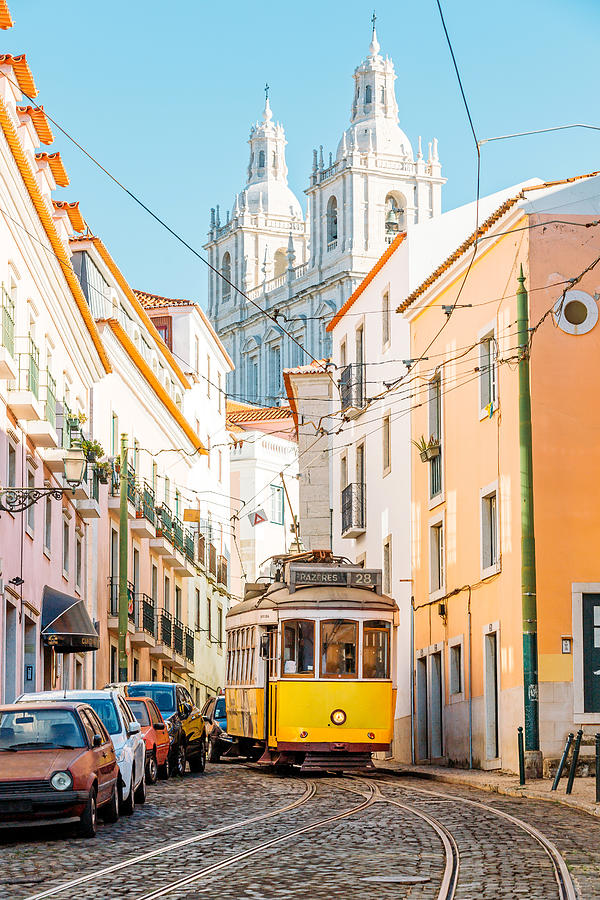 Yellow tram on the narrow street of Alfama district in Lisbon, Portugal Photograph by Alexander Spatari