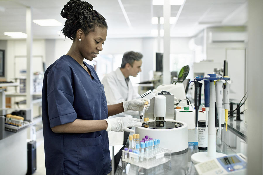 Young African Female Pathology Technician Working in Lab Photograph by Xavierarnau