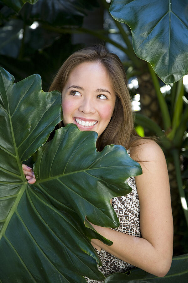 Young asian girl standing in leaves Photograph by Reggie Casagrande