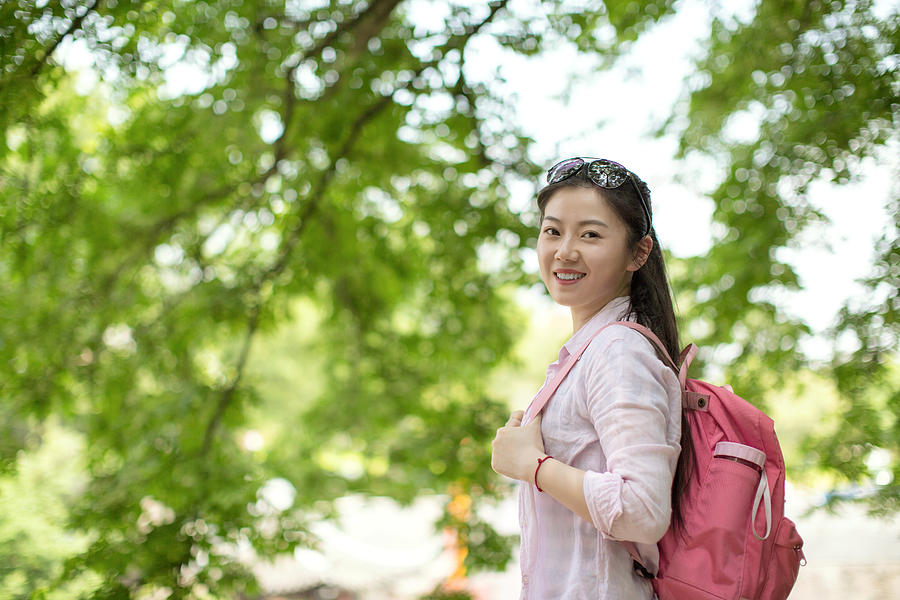 Young asian woman under tree,smiling and looking to camera Photograph by Xia Yuan