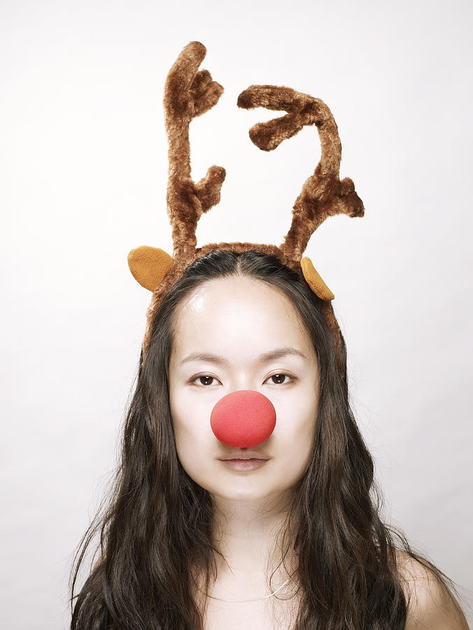 Young asian woman wearing antlers and nose  Photograph by Ballyscanlon