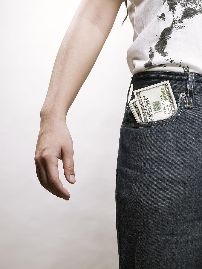 Young asian woman with dollar bills in pocket Photograph by Ballyscanlon