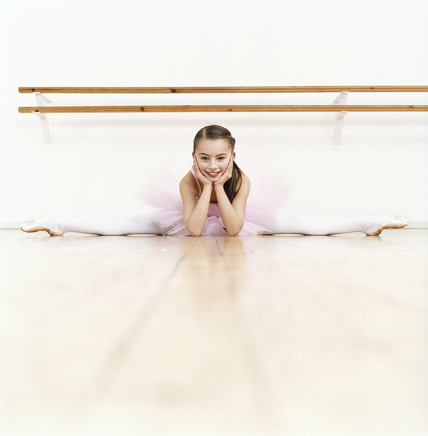 Young Ballet Dancer Doing the Splits in a Dance Studio Photograph by Digital Vision.