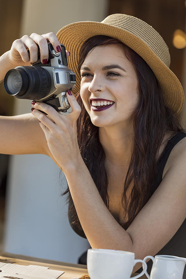 Young Beautiful Traveler Happily Taking Photos With Camera At Ca Photograph by GeoffGoldswain