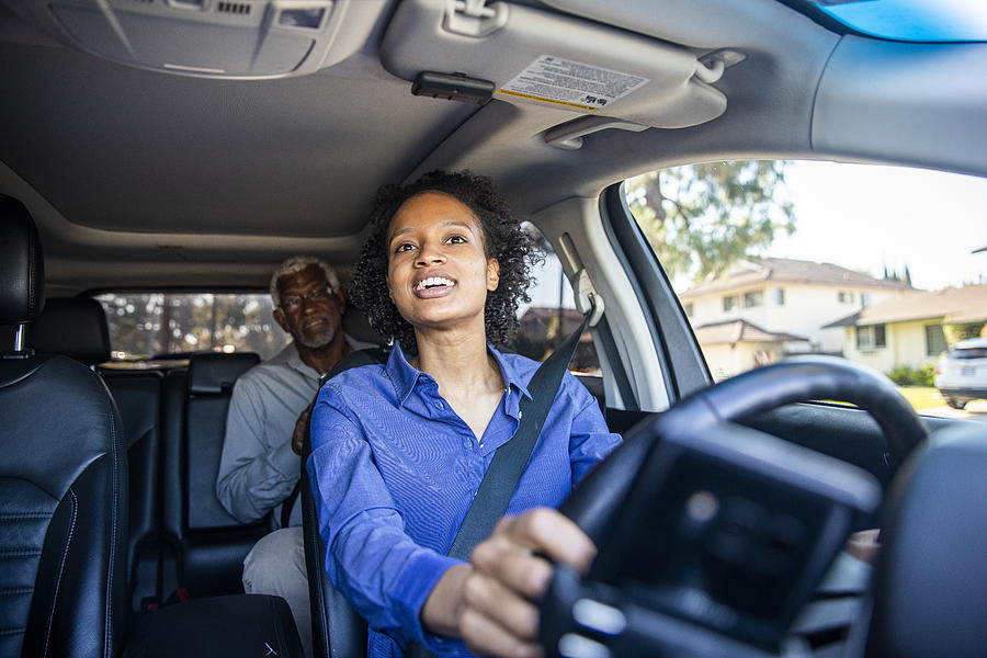 Young Black Woman Driving Car for Rideshare Photograph by Adamkaz