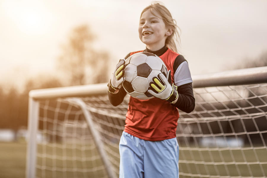 Young Blonde Female Soccer Goalkeeper Girl during football training Photograph by Lorado