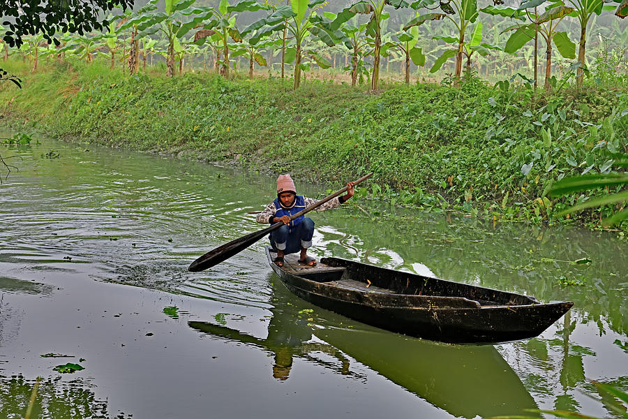 Young Boatman guiding his boat upstream Photograph by Amazing Action Photo Video
