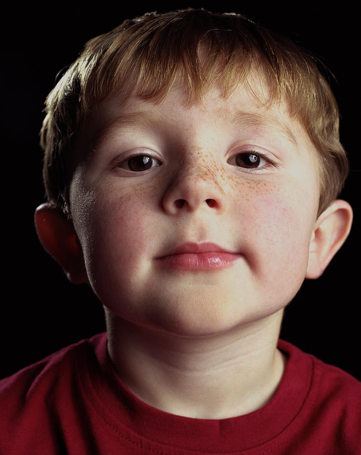 Young boy (4-6) with freckles across nose, high section, close-up Photograph by Ryan McVay