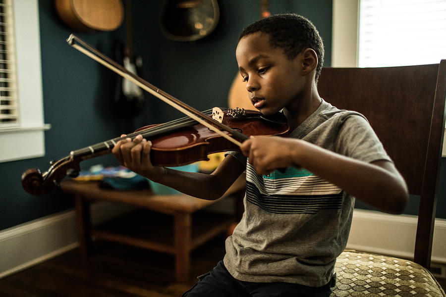Young boy (6 yrs) practicing violin Photograph by MoMo Productions
