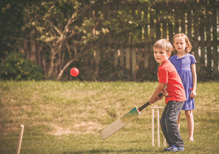 Young boy and girl play cricket Photograph by Deborah Pendell