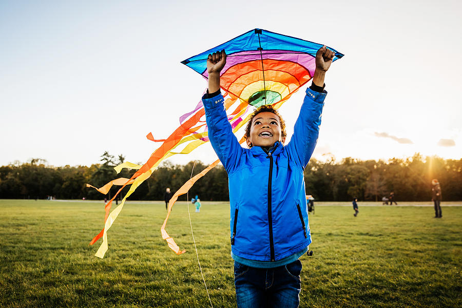 Young Boy Enjoying Learning How To Fly Kite Photograph by Tom Werner