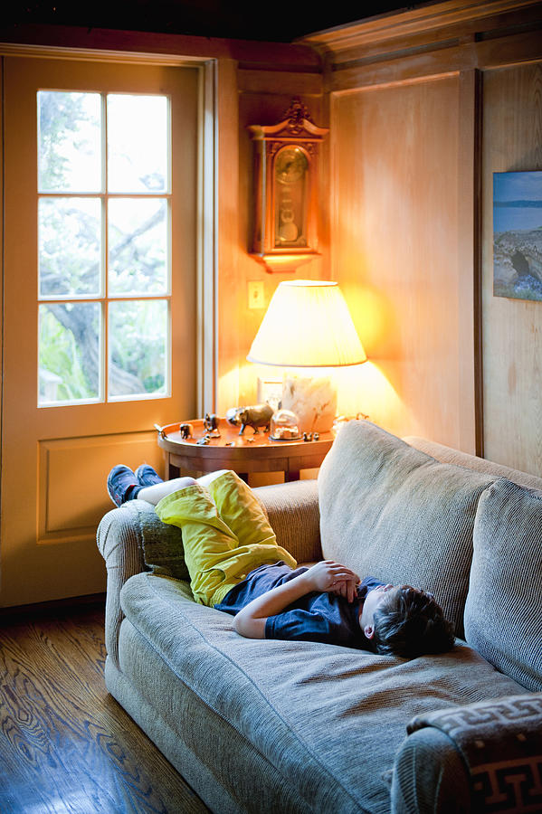 Young Boy Napping On A Couch Photograph by Stephen Simpson