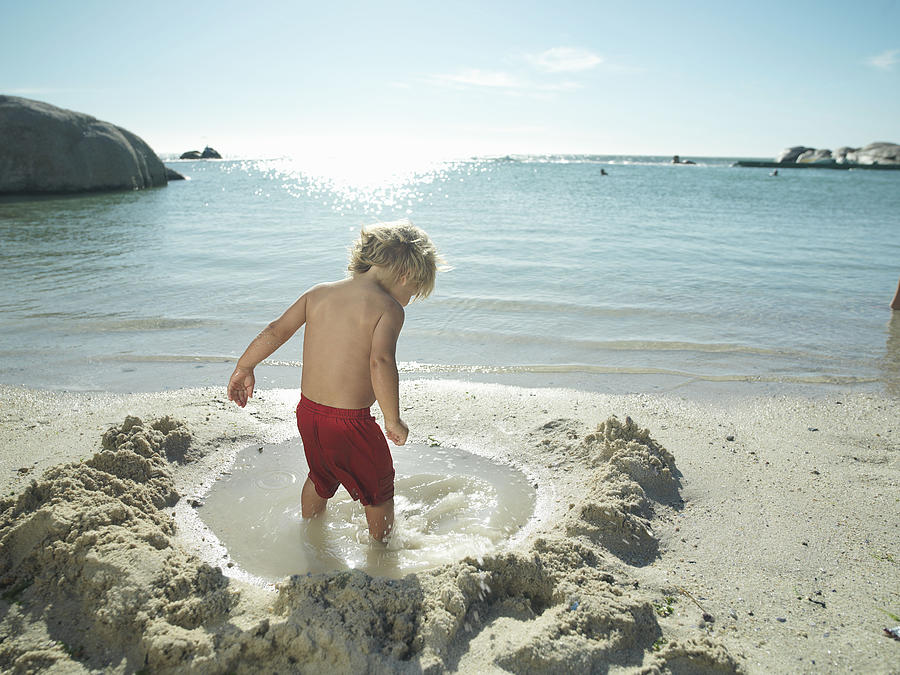Young boy playing by the sea. Photograph by David Trood