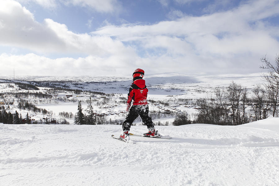 Young boy skiing slalom downhill in sunshine Photograph by Anders Sellin