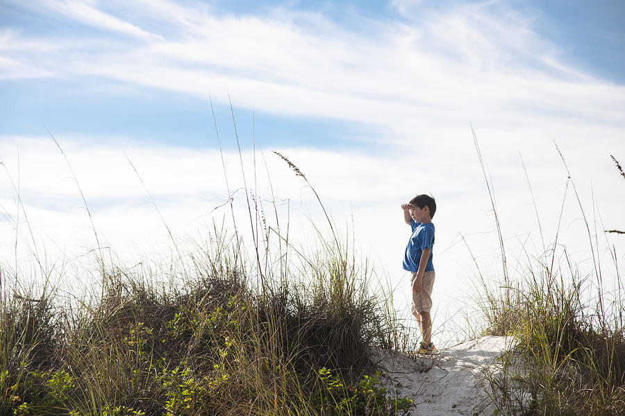 Young Boy standing on top of a Beach Dune Photograph by Chris Stein