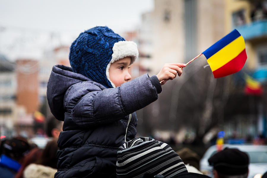 Young boy waving Romanian flag on Romania Unification Day Photograph by Adam Petto