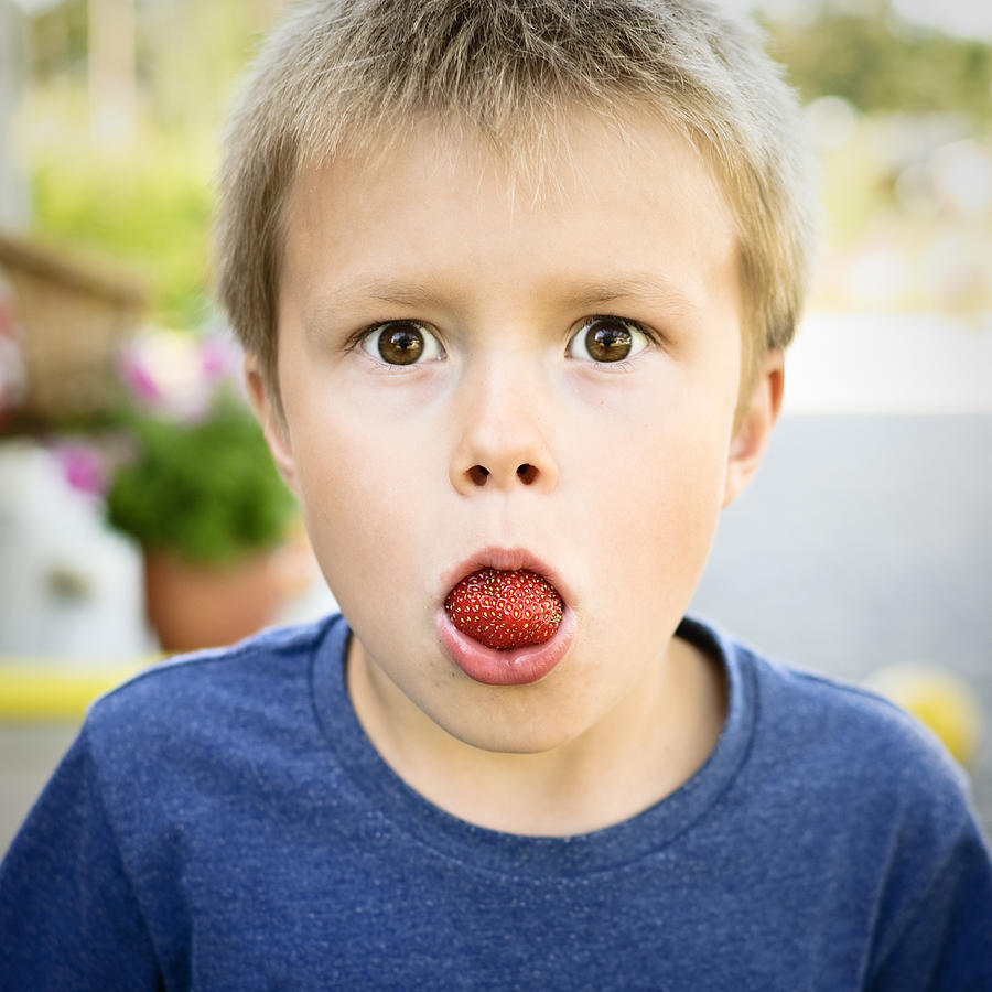 Young Boy with Strawberry in Mouth Photograph by JKristoffersson